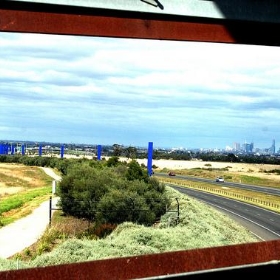 Melbourne City skyline from Whittlesea Gardens Footbridge over the Hume Freeway - Takver